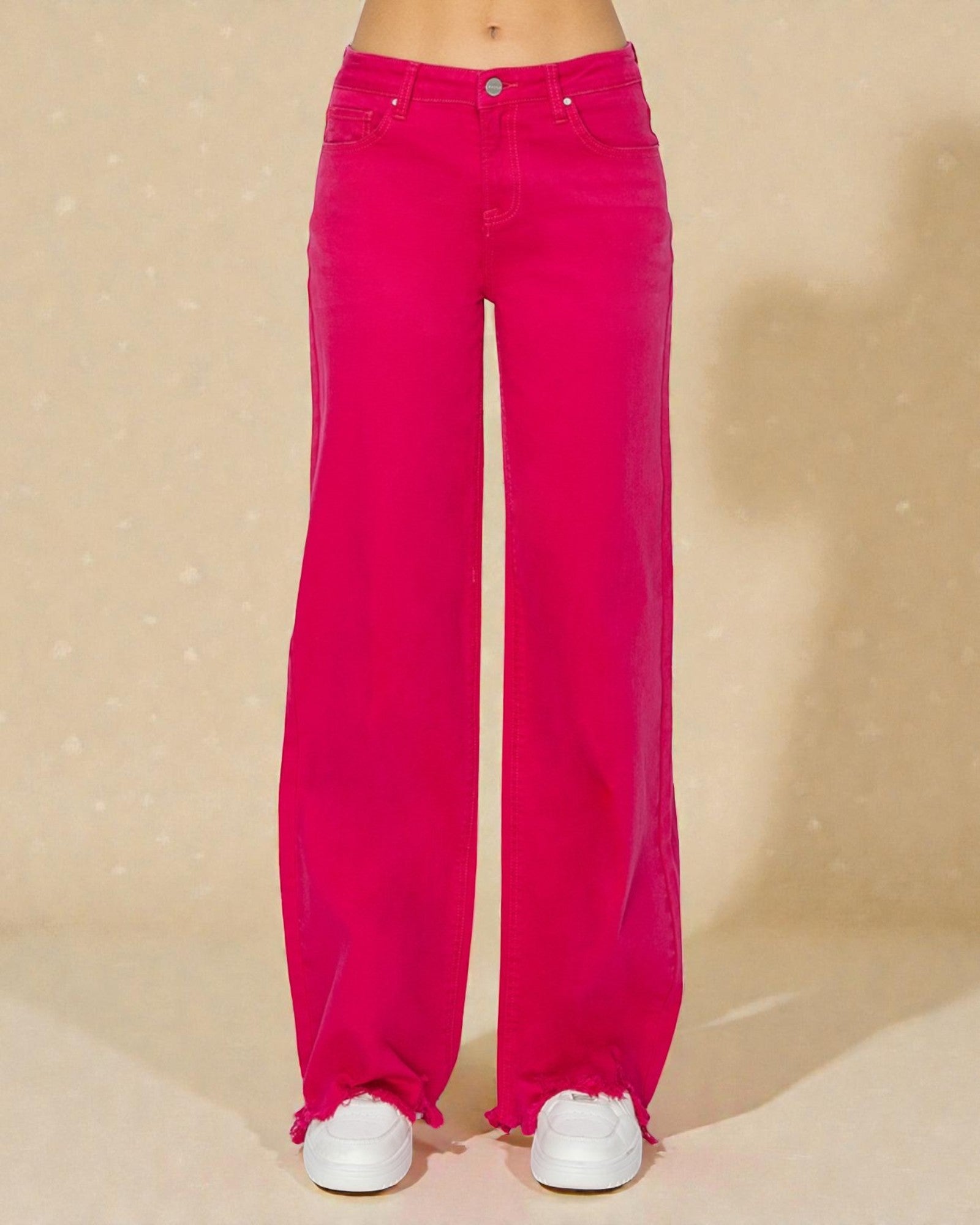 Bright pink wide-leg jeans on a beige background