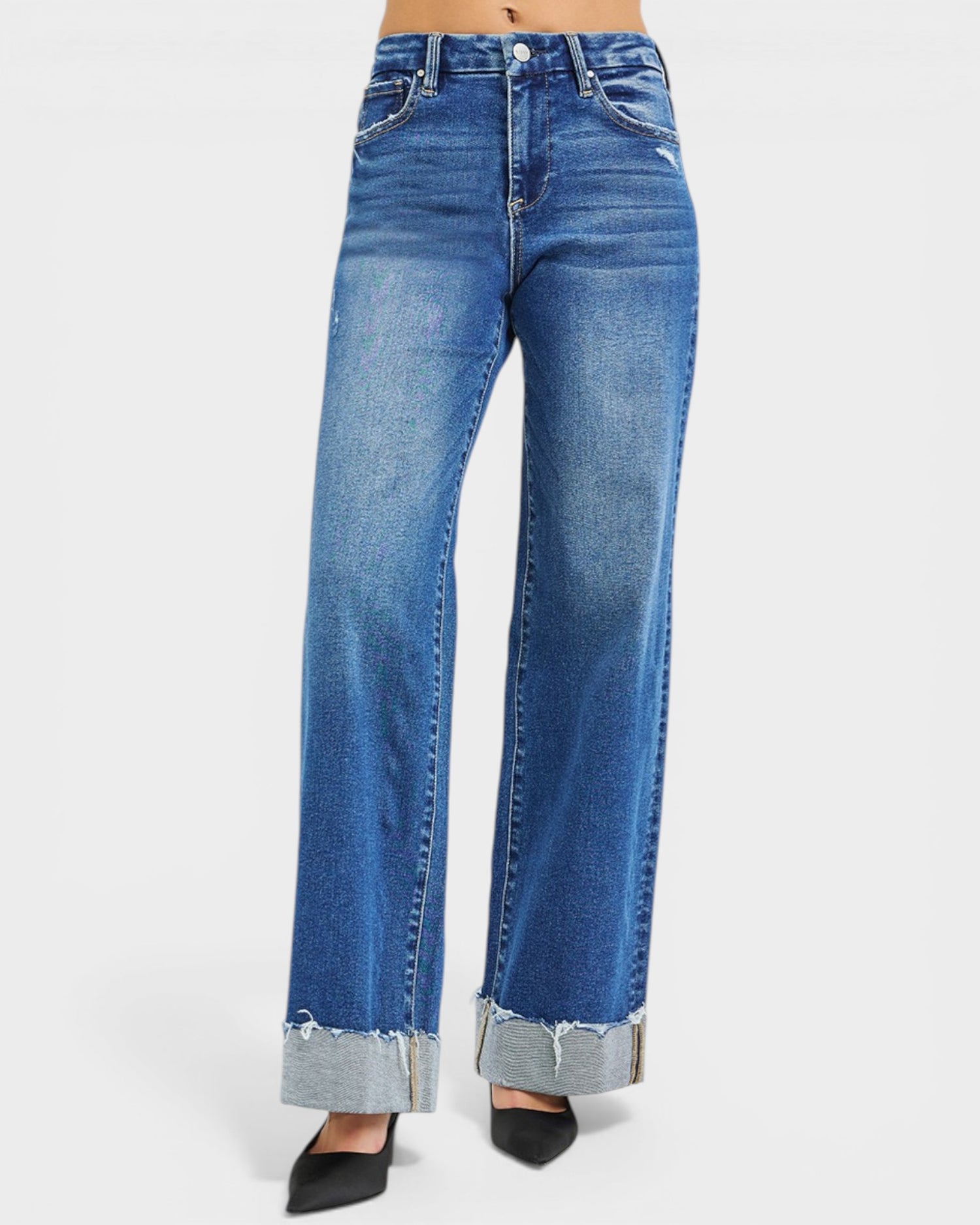 Blue jeans with rolled-up cuffs on a white background