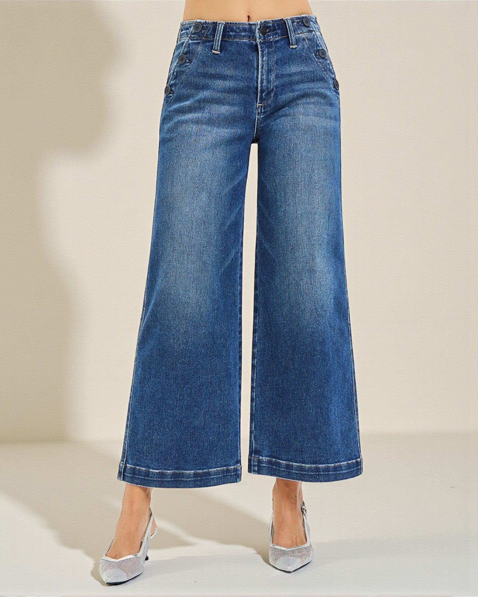 Blue wide-leg jeans on a neutral background