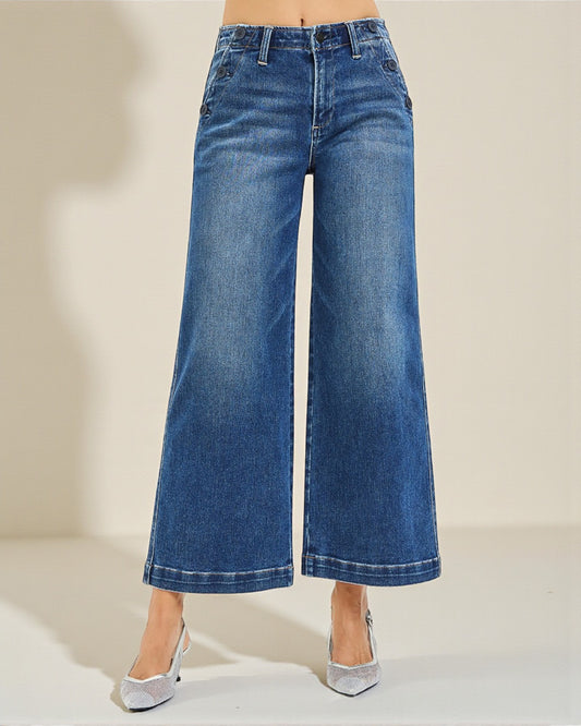 Blue wide-leg jeans on a neutral background