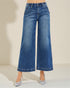 Blue wide-leg jeans on a neutral background