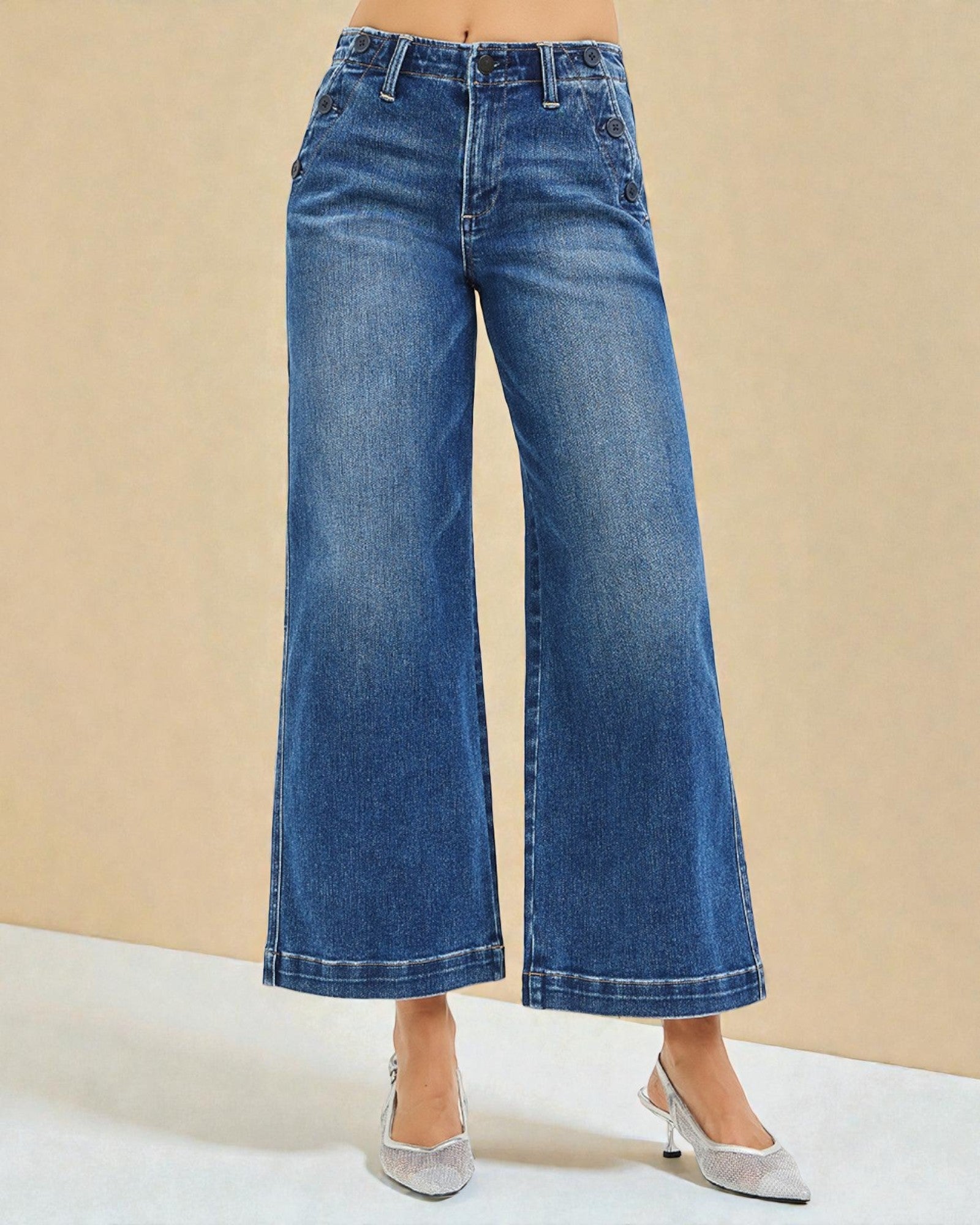 Blue wide-leg jeans worn by a person on a beige background