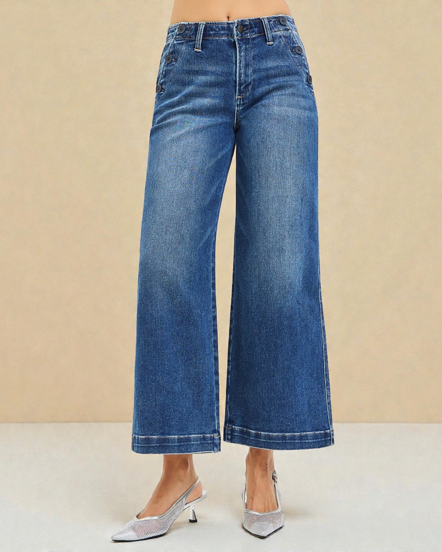 Blue wide-leg jeans worn by a person on a beige background