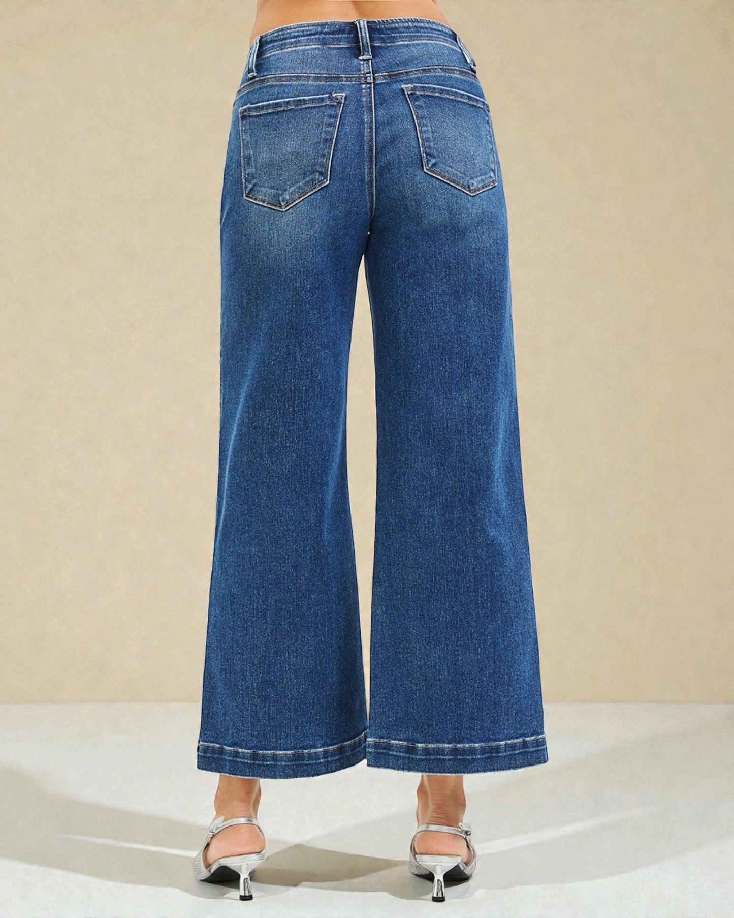 Blue wide-leg jeans on a neutral background