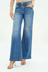 Person wearing blue flared jeans on a white background