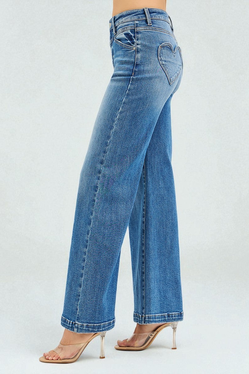 Blue jeans worn by a person on a white background