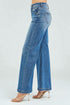 Blue jeans worn by a person on a white background