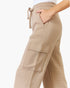 Beige wide-leg cargo sweatpants with a drawstring waist, side pockets, and a large cargo pocket on the leg, shown on a model against a white background.