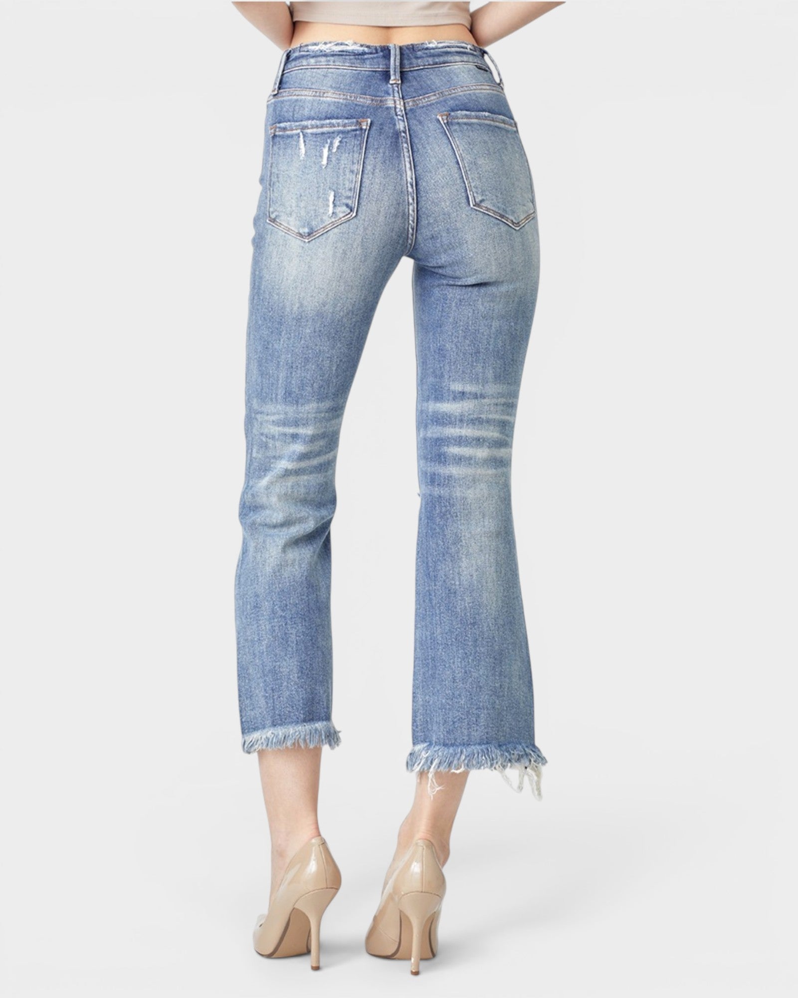 Blue jeans worn by a person on a white background