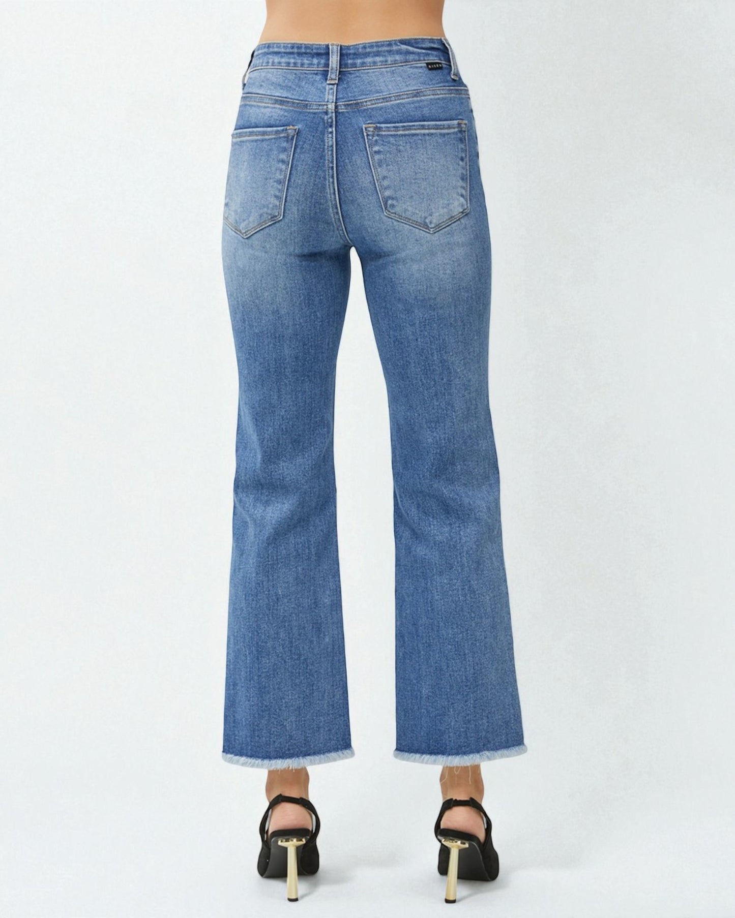 Blue jeans worn by a person on a white background