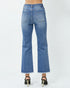 Blue jeans worn by a person on a white background