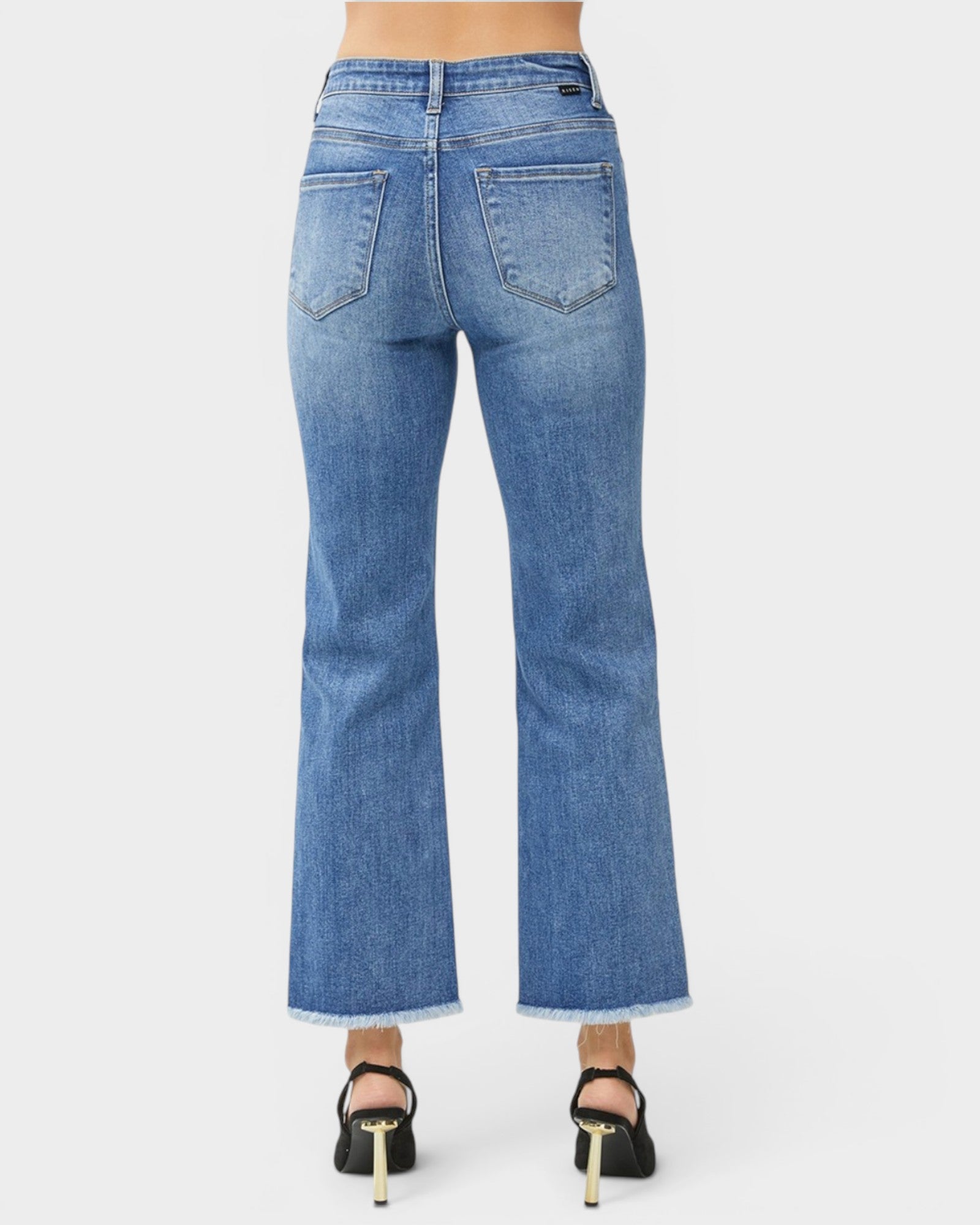 Blue jeans worn by a person on a white background