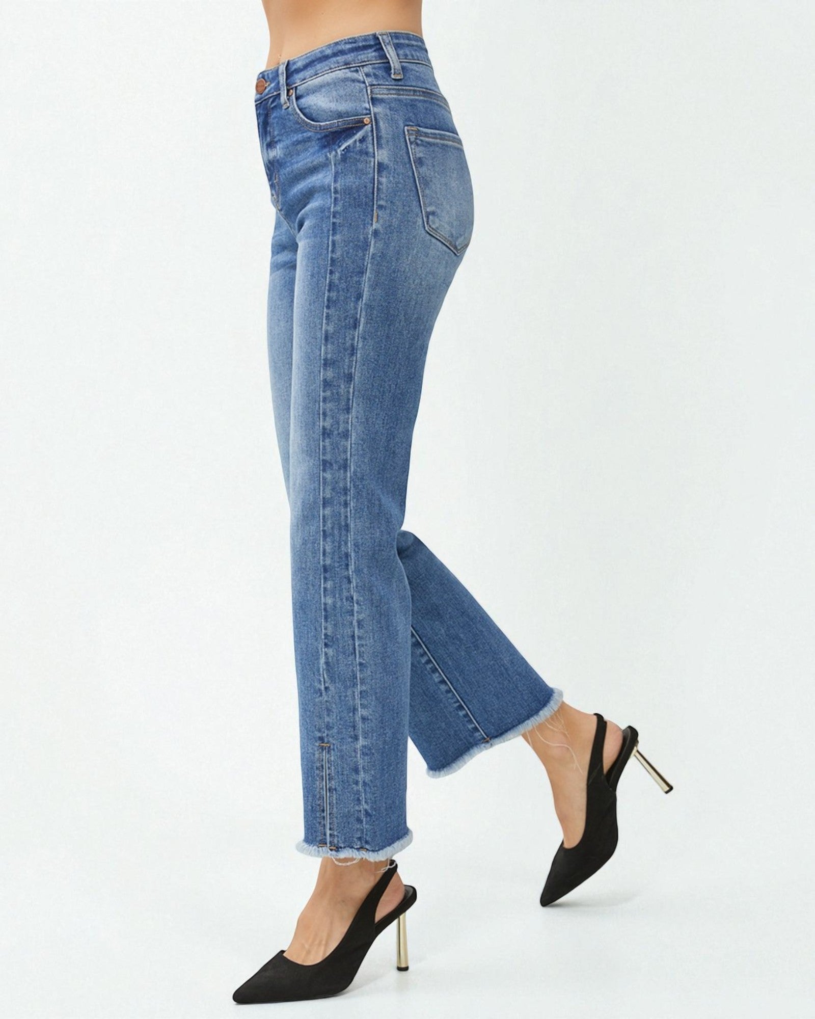 Blue jeans worn by a person on a white background