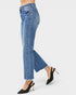 Blue jeans worn by a person on a white background
