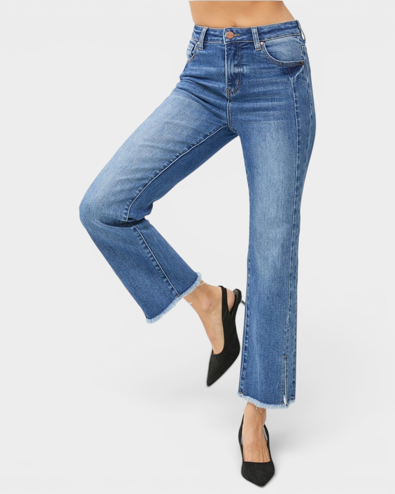 Blue jeans worn by a person on a white background