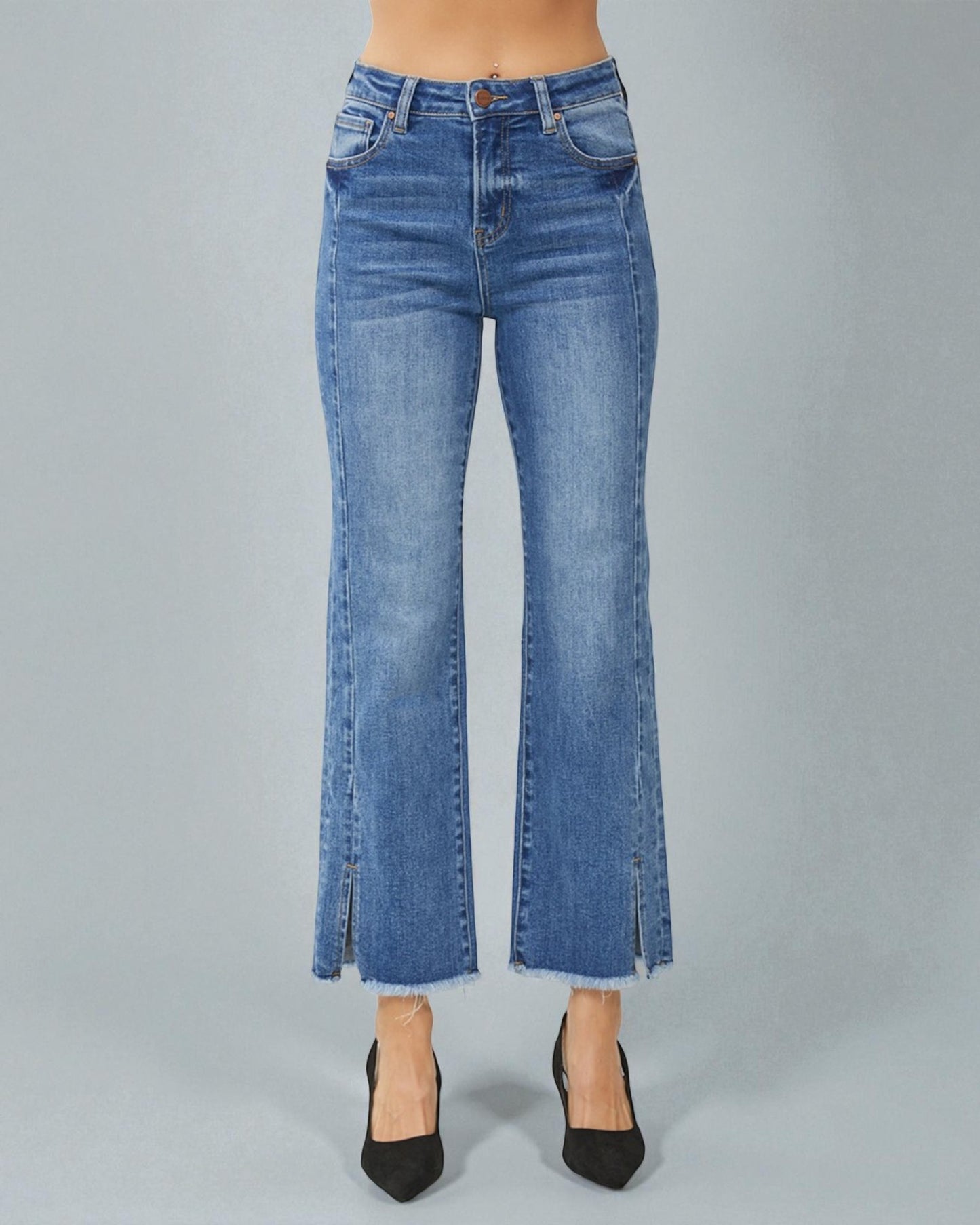 Blue jeans with a slit on a gray background