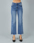Blue jeans with a slit on a gray background
