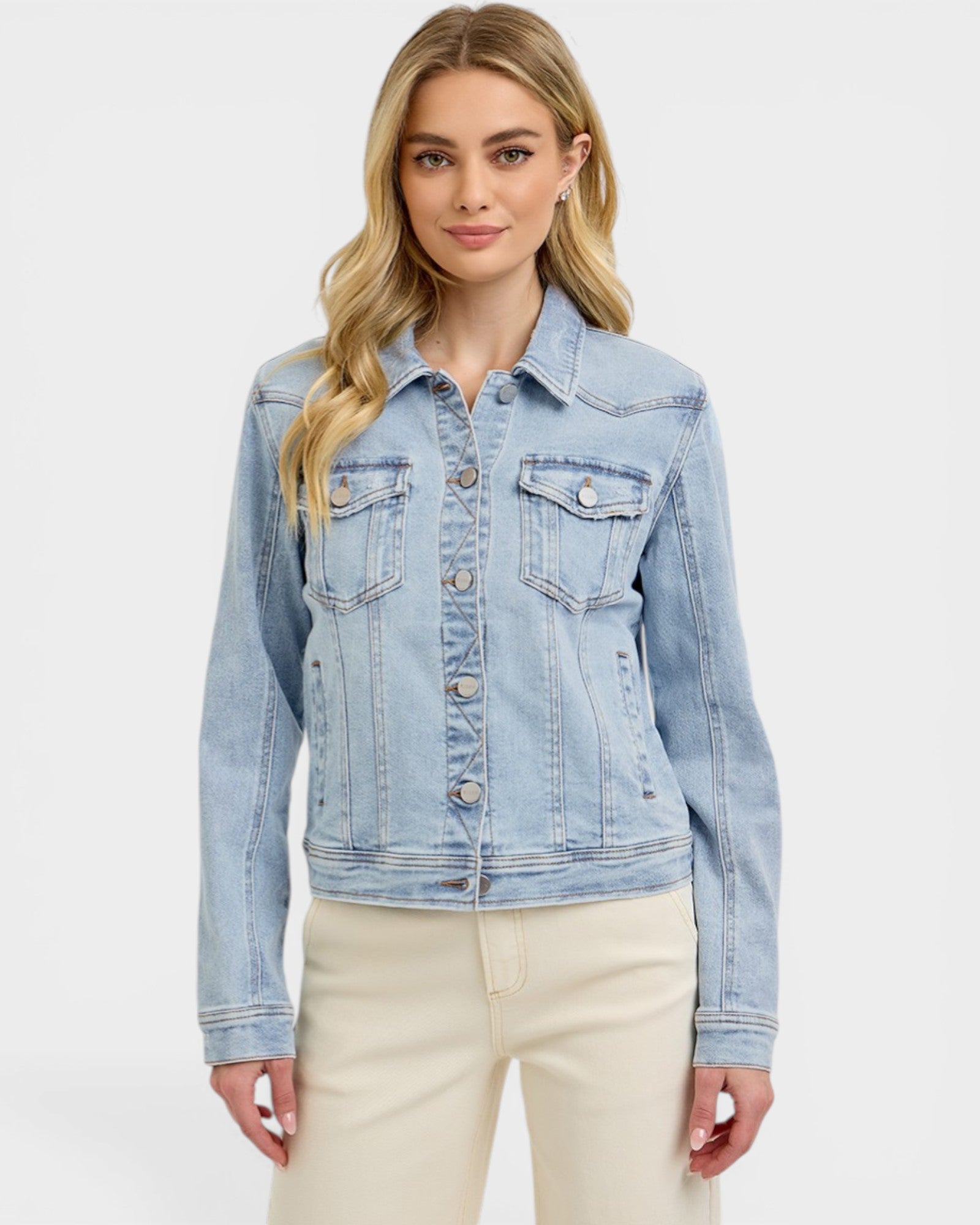 Woman wearing a light blue denim jacket on a white background