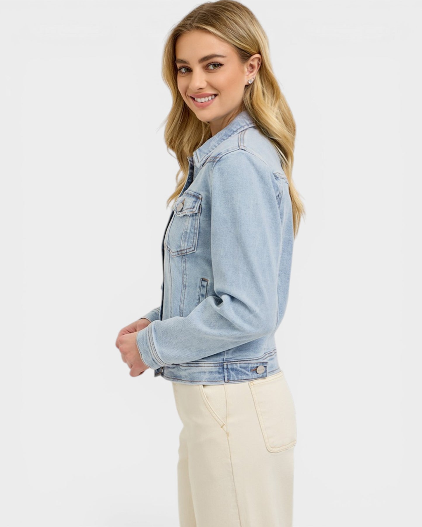 Woman wearing a light blue denim jacket on a white background
