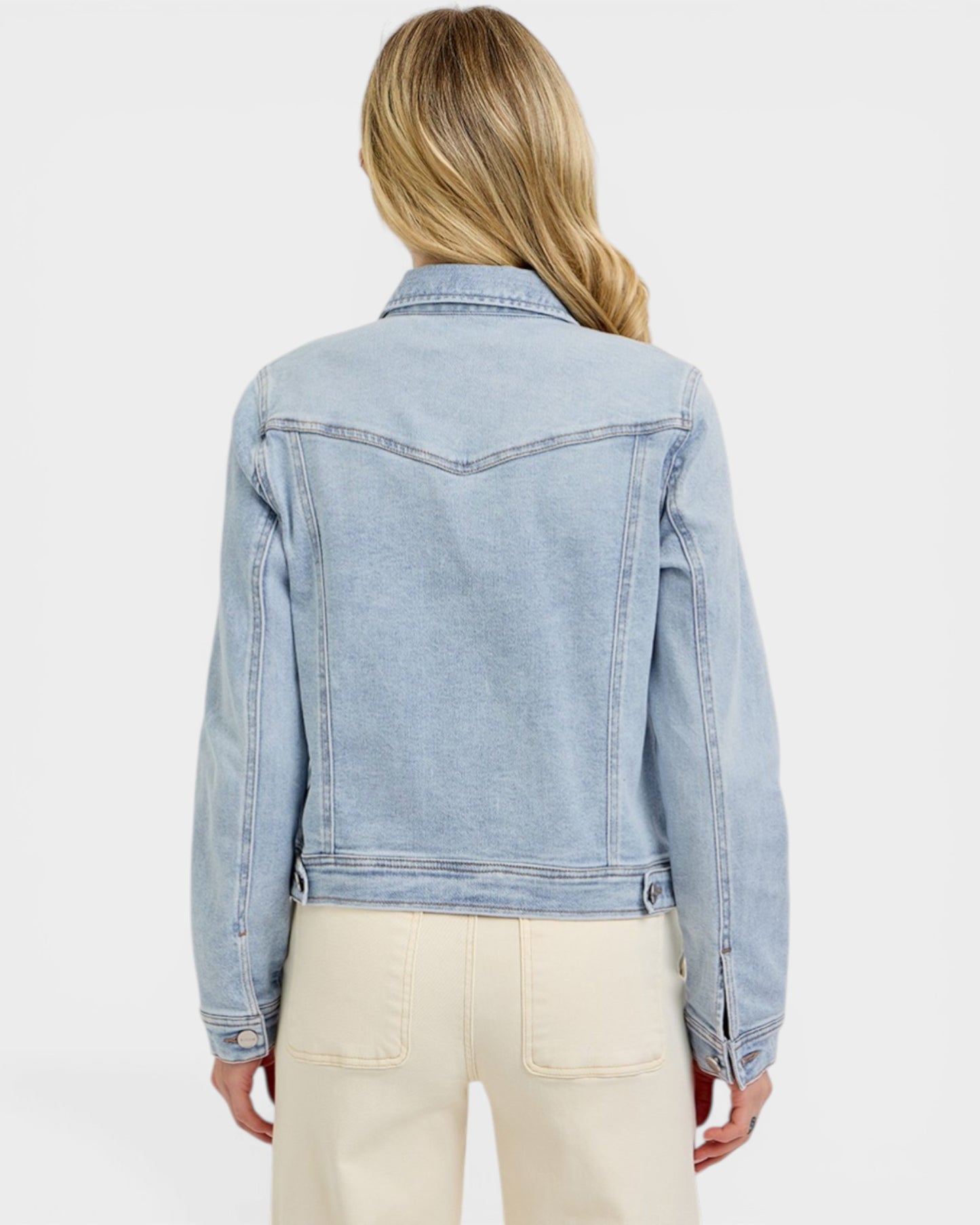 Light blue denim jacket worn by a person on a white background