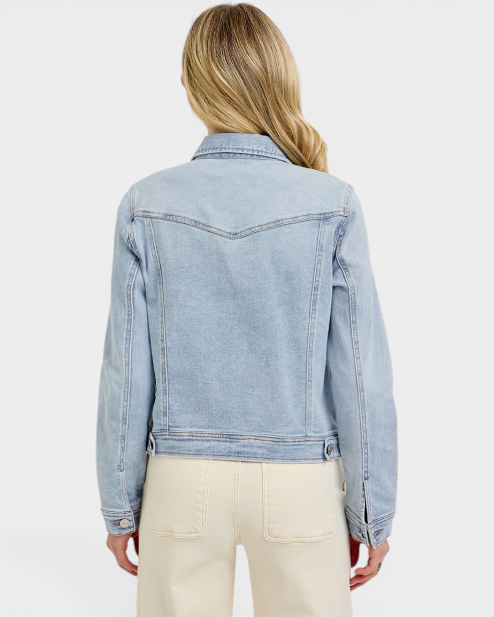 Light blue denim jacket worn by a person on a white background