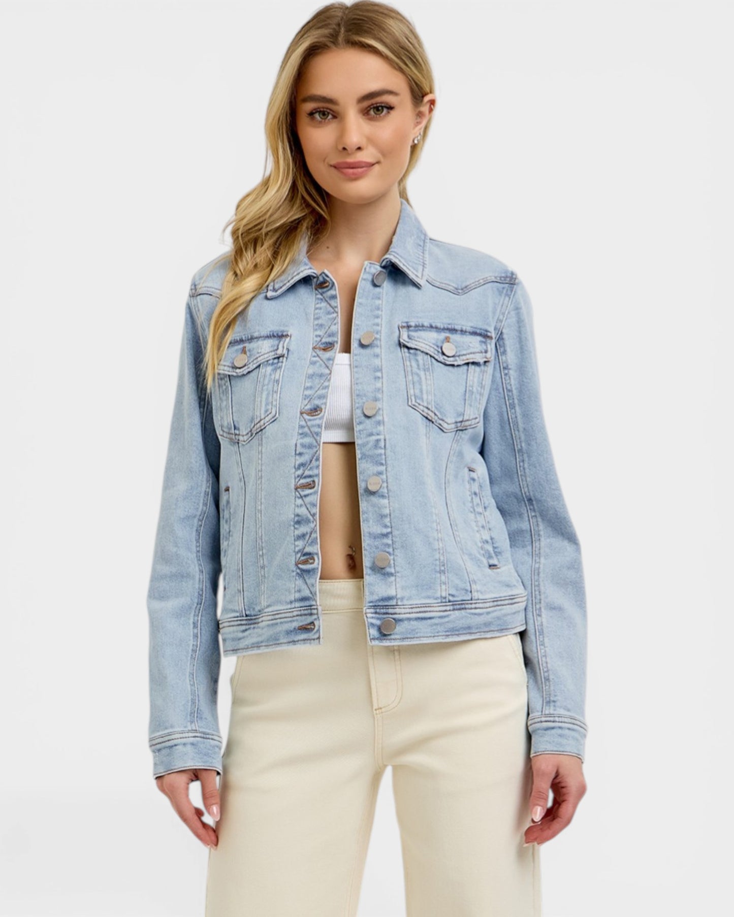 Woman wearing a light blue denim jacket on a white background