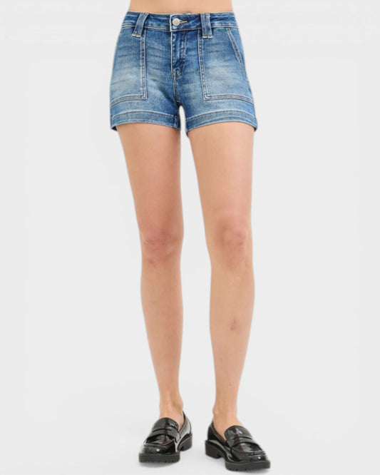 Person wearing blue denim shorts on a white background