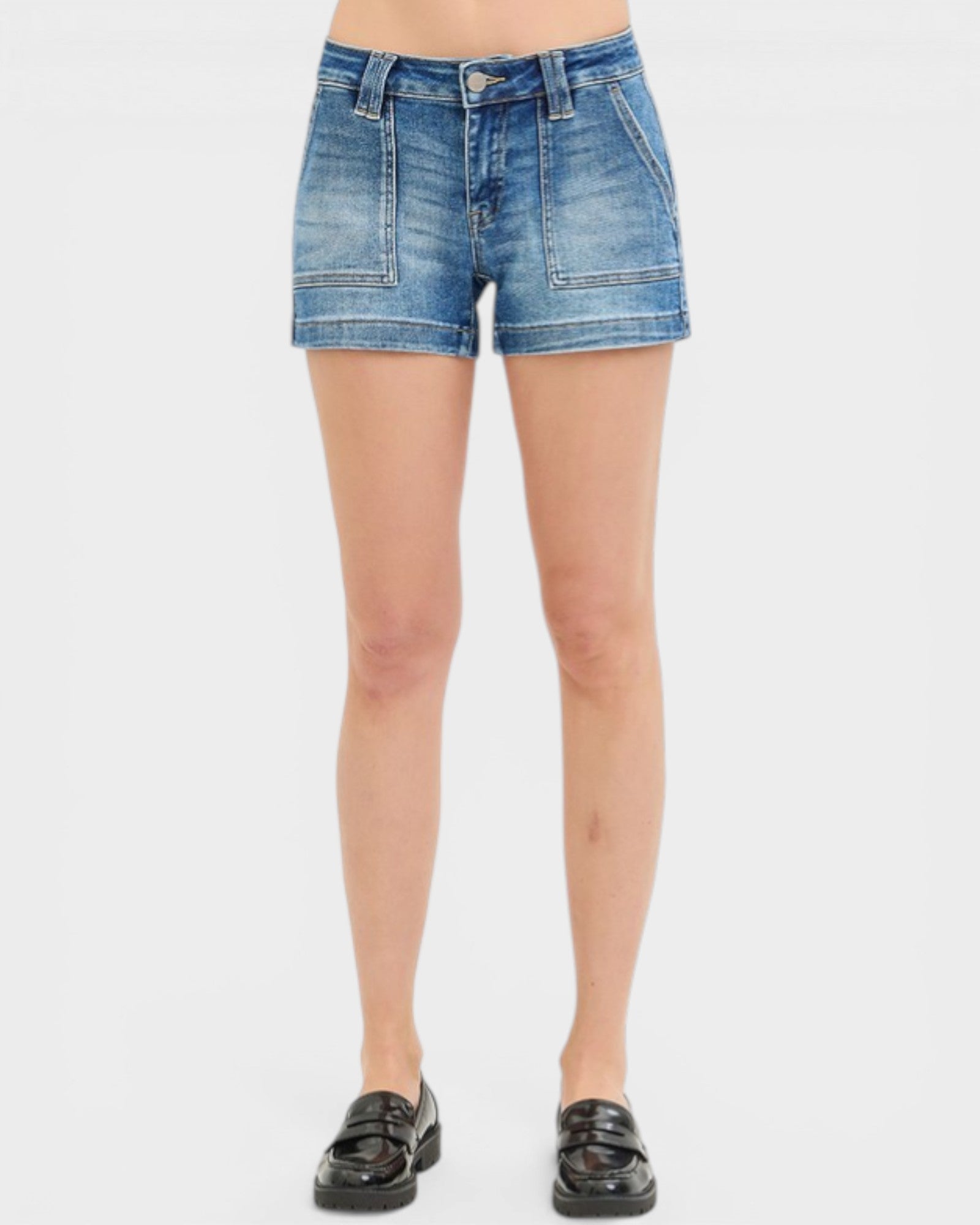 Denim shorts worn by a person on a white background