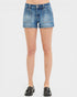 Denim shorts worn by a person on a white background