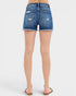 Blue denim shorts worn by a person on a white background