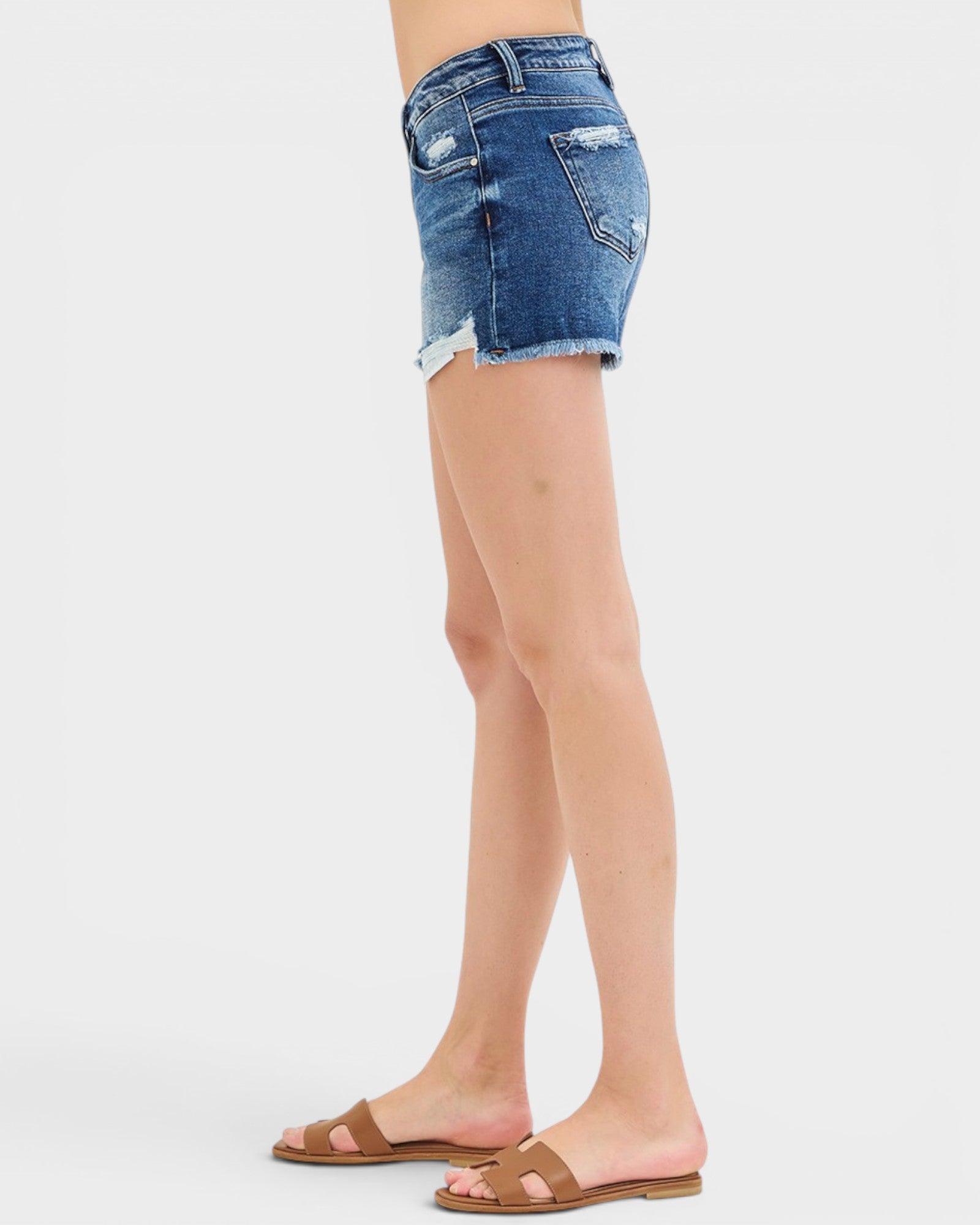 Denim shorts worn by a person on a white background