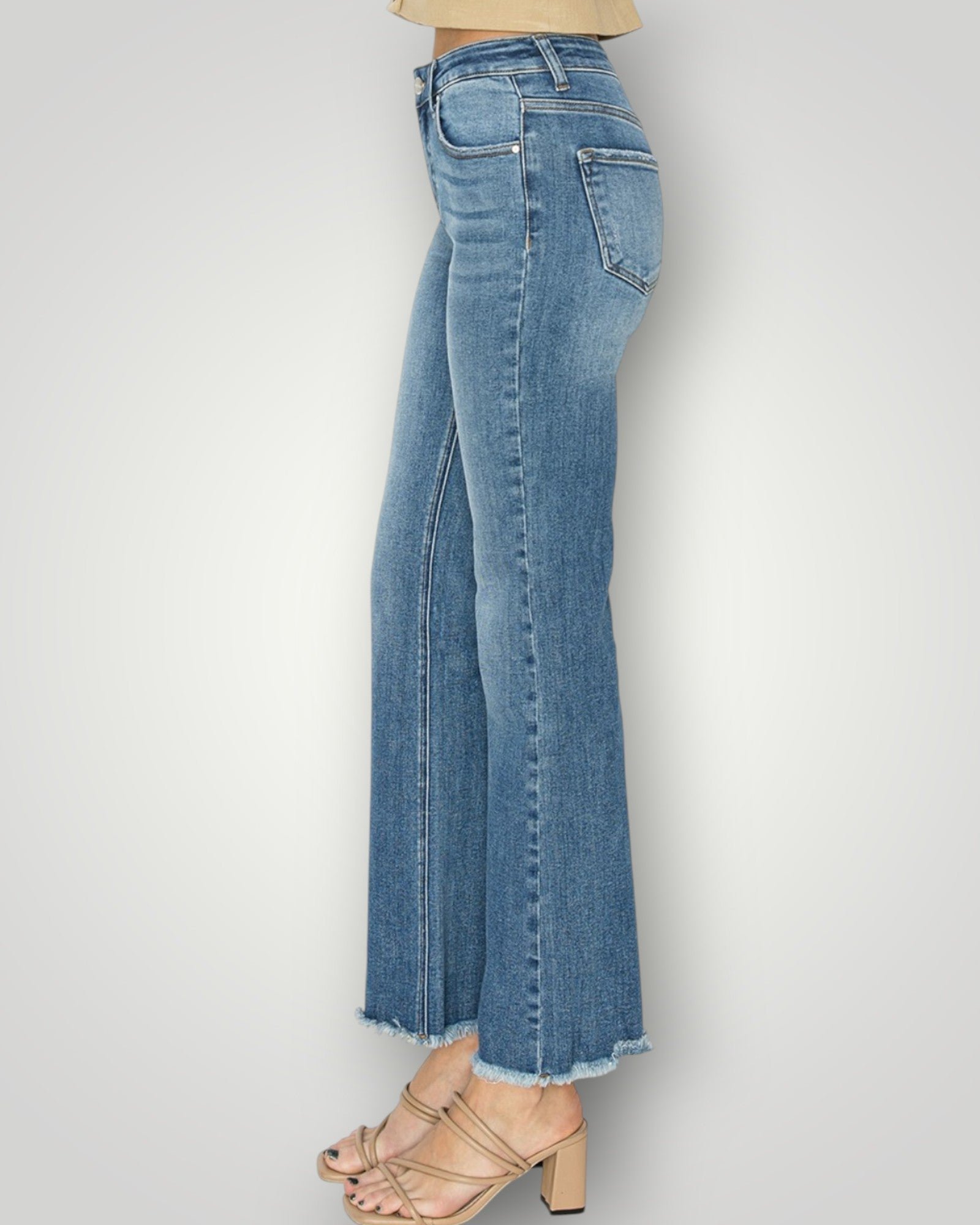 Blue jeans worn by a person on a white background