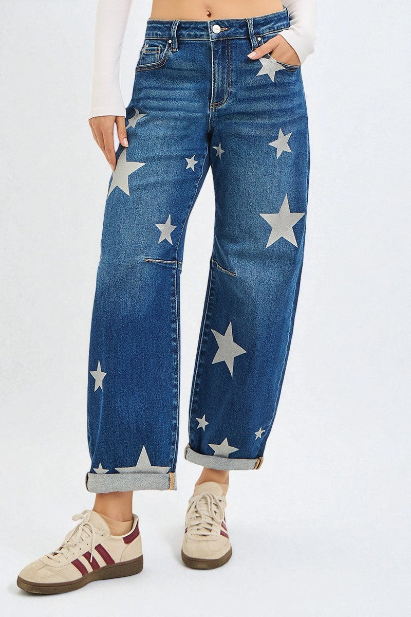 Blue jeans with star patterns worn by a person on a white background