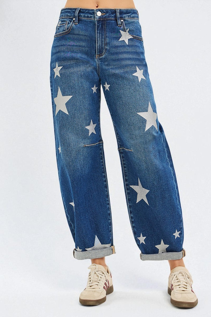 Blue jeans with star patterns worn by a person on a white background
