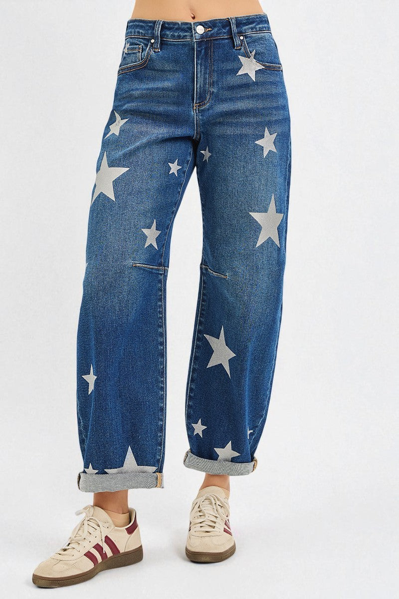 Blue jeans with star patterns worn by a person on a white background