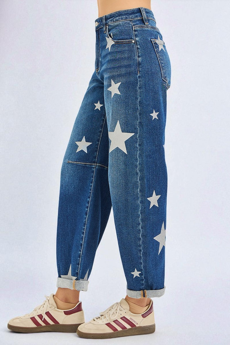 Blue jeans with white star patterns worn by a person on a light gray background