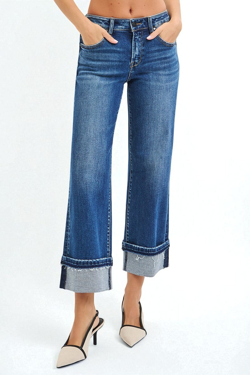 Blue jeans worn by a person on a white background