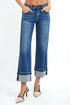 Blue jeans worn by a person on a white background