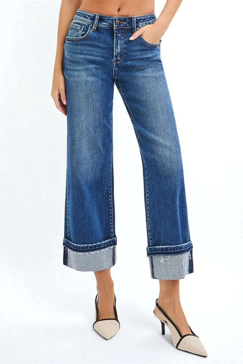Person wearing blue jeans with a white background