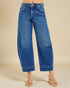 Blue jeans worn by a person on a beige background