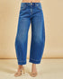 Blue jeans worn by a person on a beige background