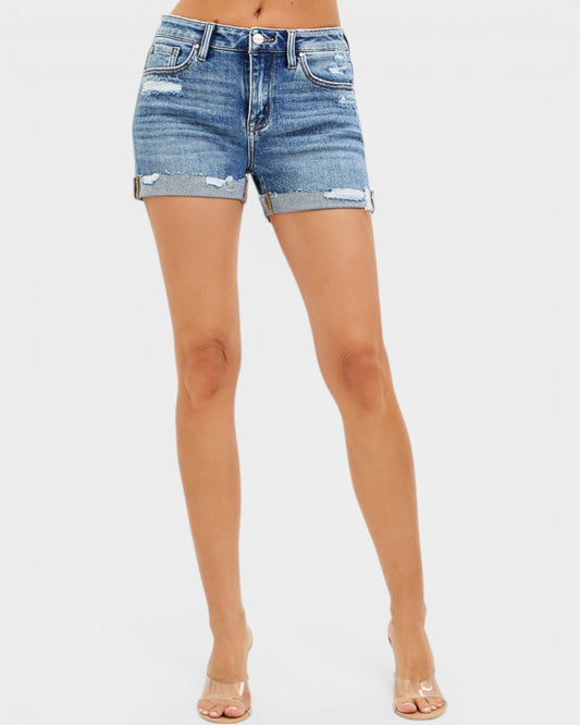 Denim shorts worn by a person on a white background
