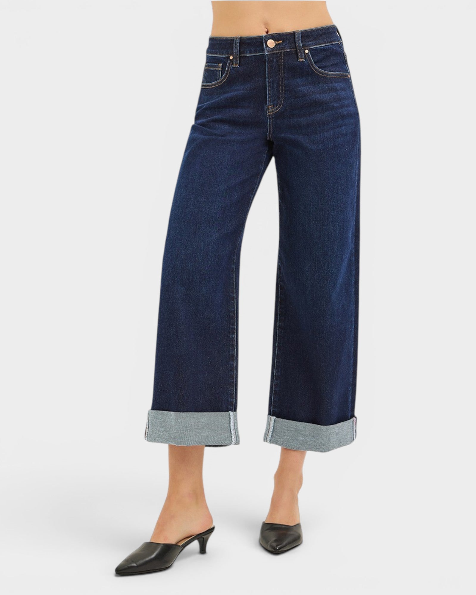 Dark blue wide-leg jeans worn by a person on a white background