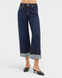 Dark blue wide-leg jeans with rolled-up hem on a white background