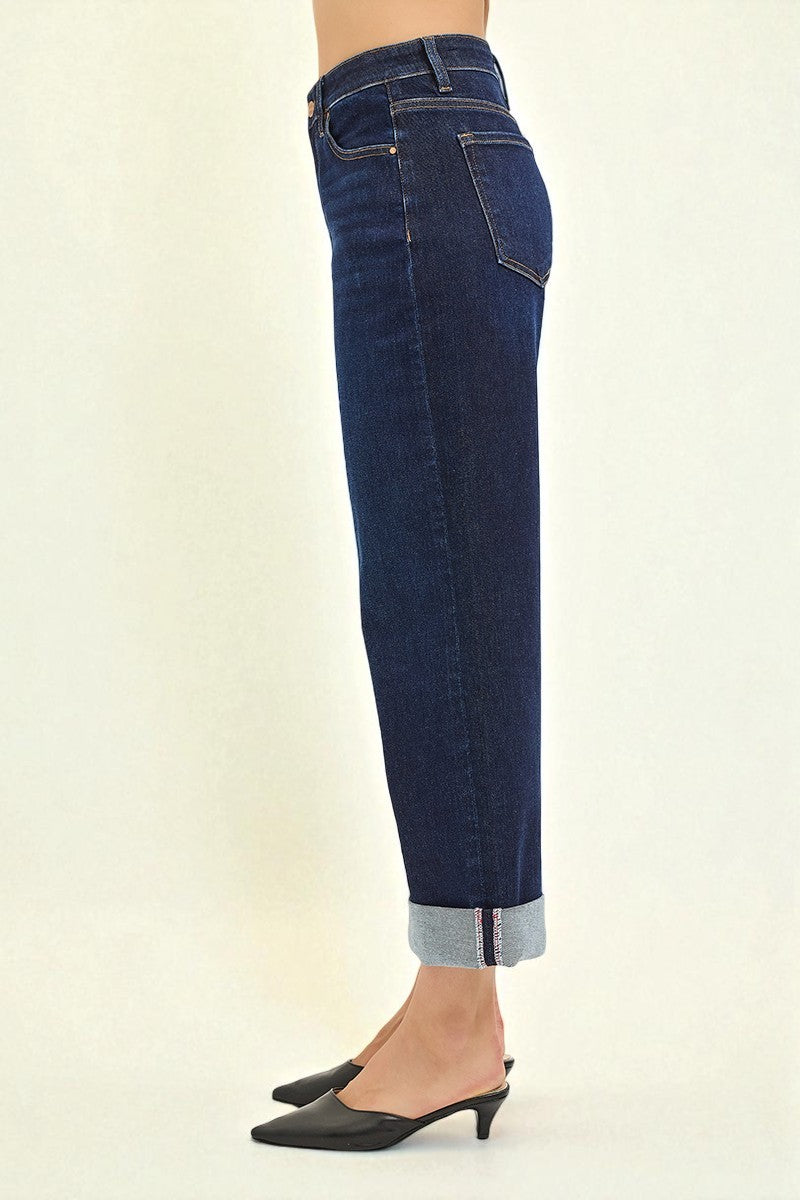 Blue jeans worn by a person on a white background