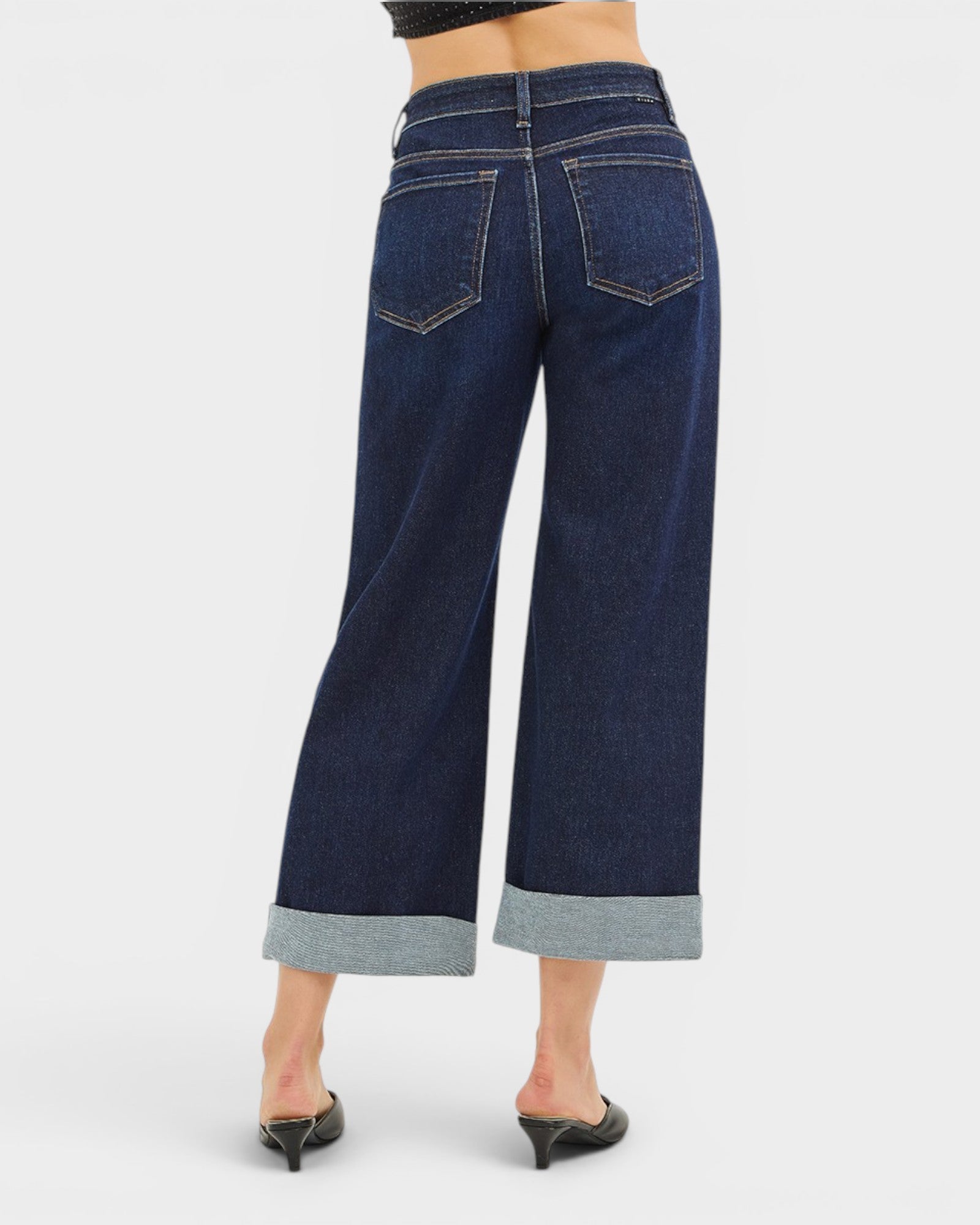 Dark blue wide-leg jeans with gray cuffs on a white background