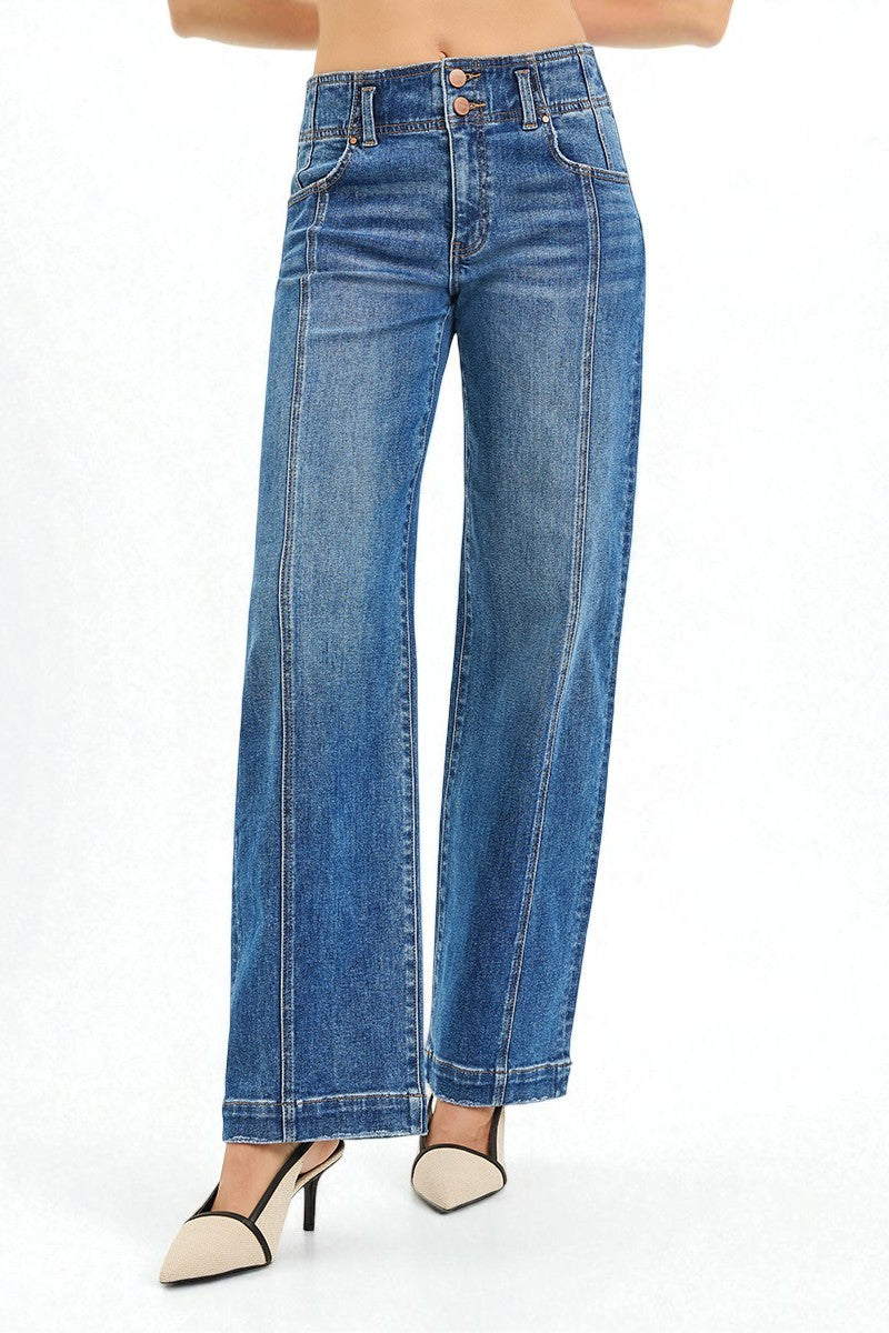 Blue jeans worn by a person on a white background
