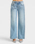 Light blue jeans worn by a person on a white background