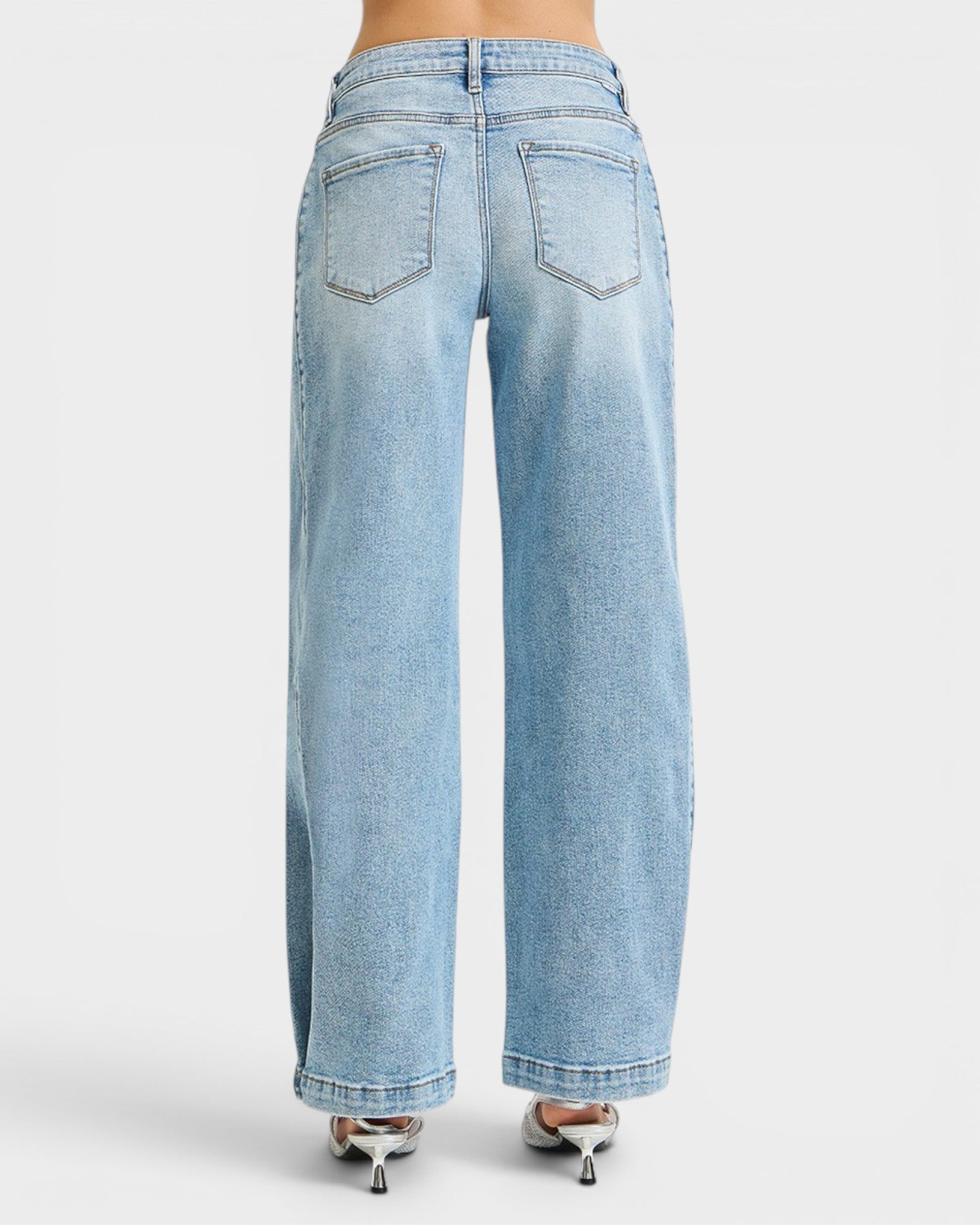 Light blue jeans worn by a person on a white background