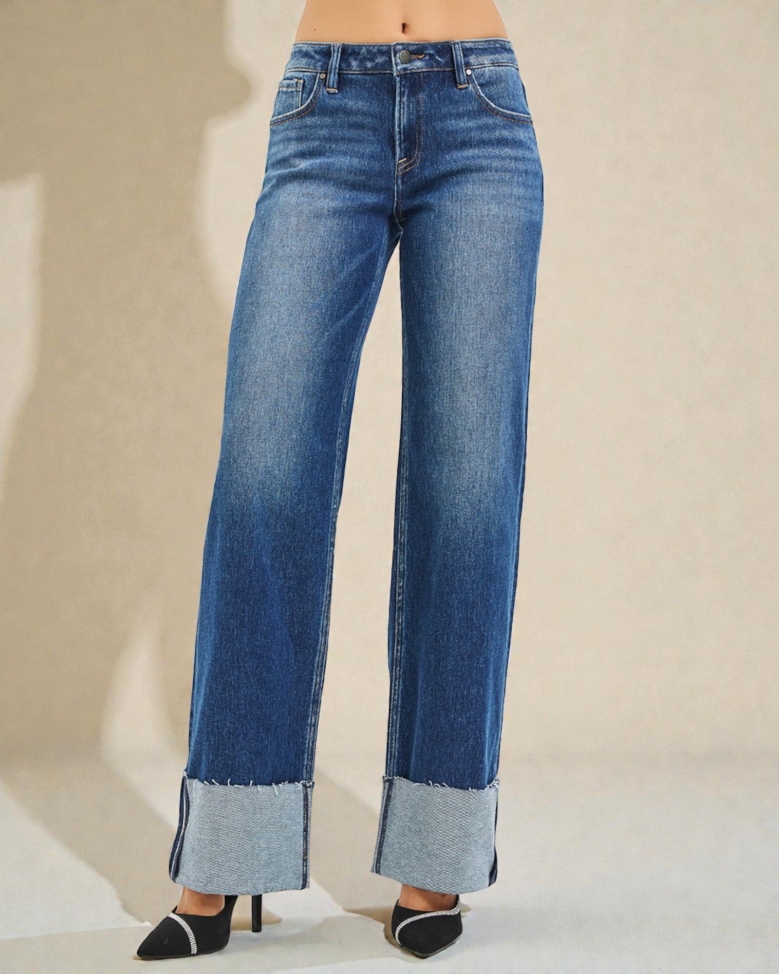 Blue wide-leg jeans on a neutral background